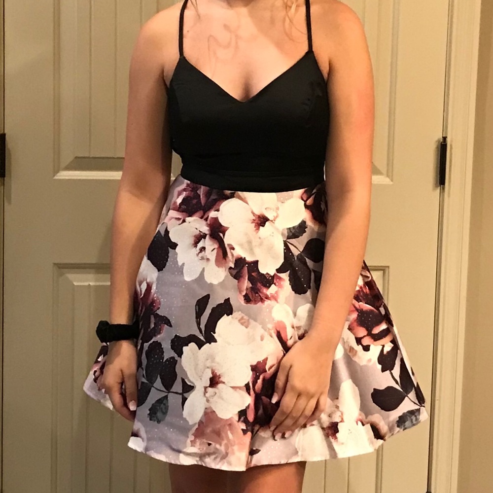 Short formal dress with open back and bow accent